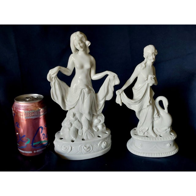A pair of Antique Art Deco Flower Frogs. The Flower Frogs are made of porcelain and depict lovely ladies. Both are signed...