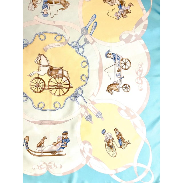 HERMES MOBILE TOYS signed Nina, pastel blue and yellow This scarf is a touching tribute to the world of childhood and its...