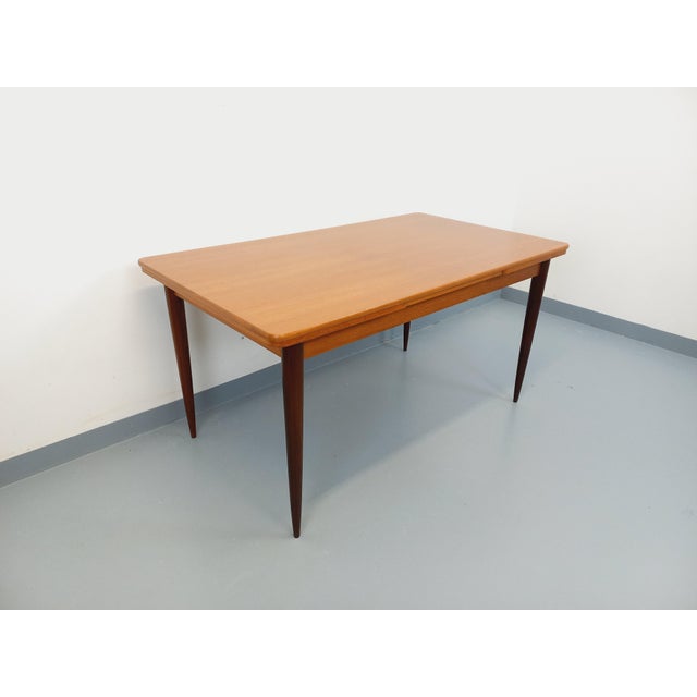 Vintage rectangular dining table from the 1950s/60s, in teak, rectangular top with rounded edges, with two integrated...