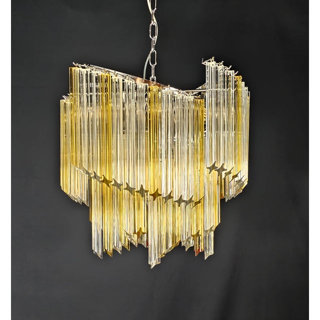 A delightful vintage murano chandelier, in the venini style. Its shape is reminiscent of ancient woven fans. It features...