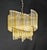 A delightful vintage murano chandelier, in the venini style. Its shape is reminiscent of ancient woven fans. It features...