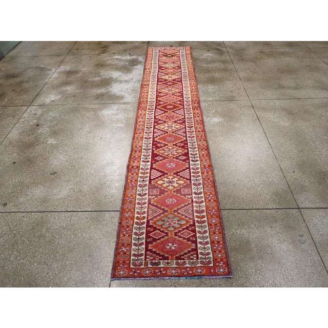 A vintage Turkish Anatolian tribal runner handmade during the mid-20th century. Measures: 2' 8" x 13' 10"