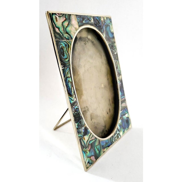 Offering an Alpaca silver and abalone shell picture frame, circa 1950s. This gorgeous small picture frame is made of...