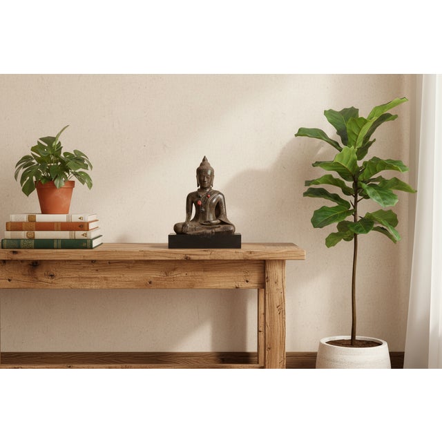 A piece of profound spiritual quietude, this antique bronze statue depicts the Buddha in the classic Bhumisparsha...