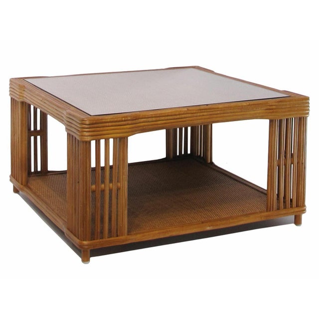 Stick Rattan “Nantucket” Square Coffee Table This striking Nantucket coffee table features a classic stick rattan framing...