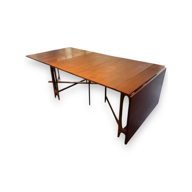 This exquisite mid-century drop-leaf dining table by Bendt Winge beautifully showcases the warmth and craftsmanship of...