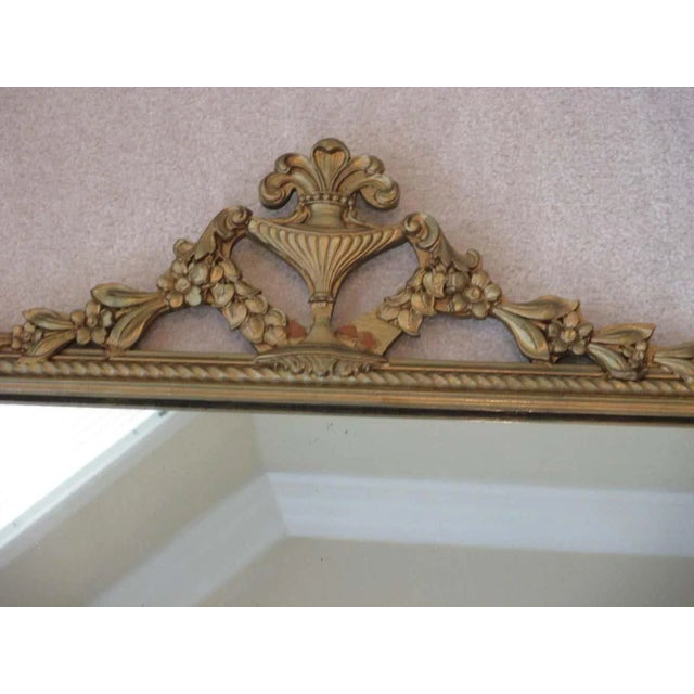 Beautiful vintage gold wooden mirror with ornate trim. Hanging hardware is attached.