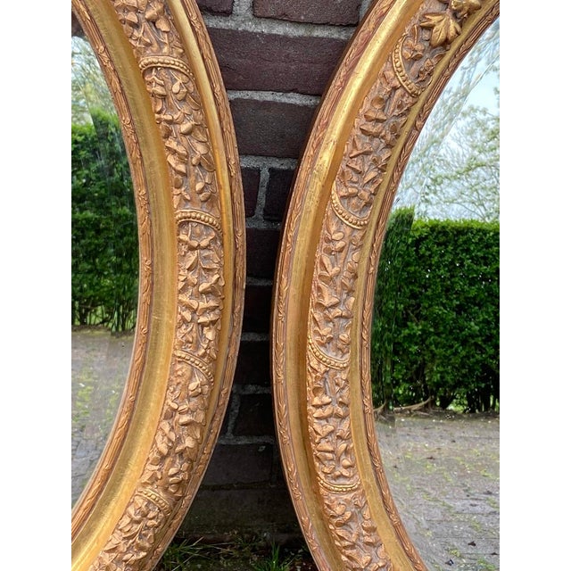 A beautiful pair of 1980s French Louis XVI-style wall mirrors, handcrafted from solid beechwood and finished in an antique...