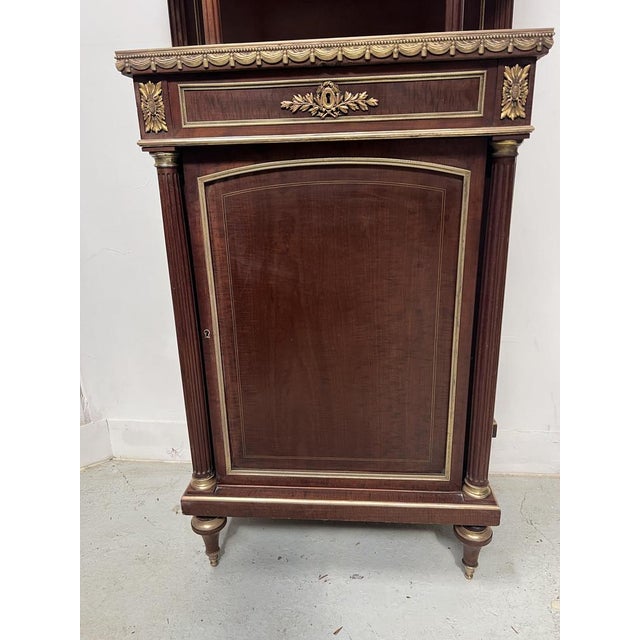 Napoleon III mahogany and chased bronze display cabinet, 19th century. The lower section is curved with one door and one...