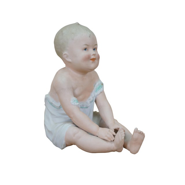 Late 19th to early 20th century porcelain bisque piano baby by Gebruder Heubach. Unglazed figurine in the shape of a blond...