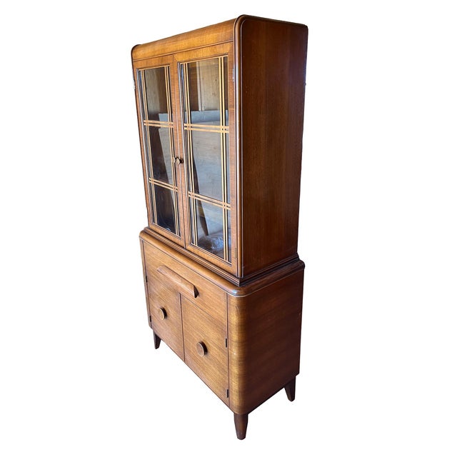 This Art Deco era china cabinet is a modest size and easy to incorporate into most rooms. The wooden grillwork on the...