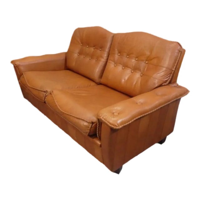 These Madsen & Schubell two seater sofas in tan brown leather are a matching pair and are in near perfect original...