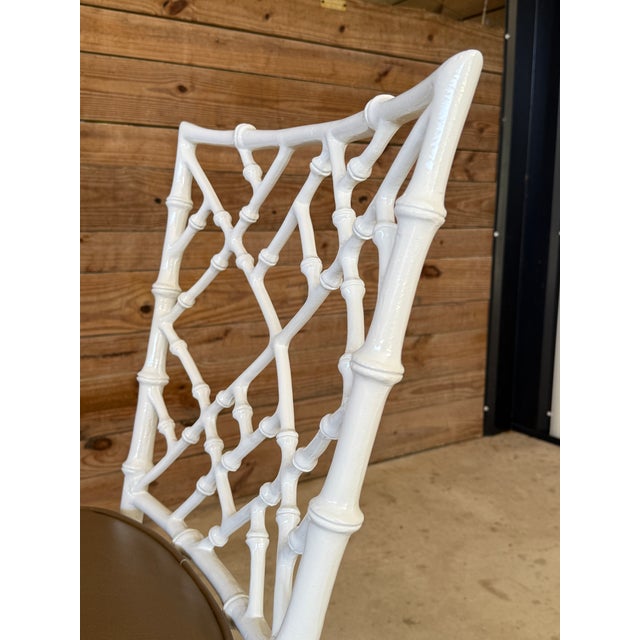 A chic and highly collectible pair of mid-20th century side chairs by Phyllis Morris, featuring iconic faux bamboo-style...