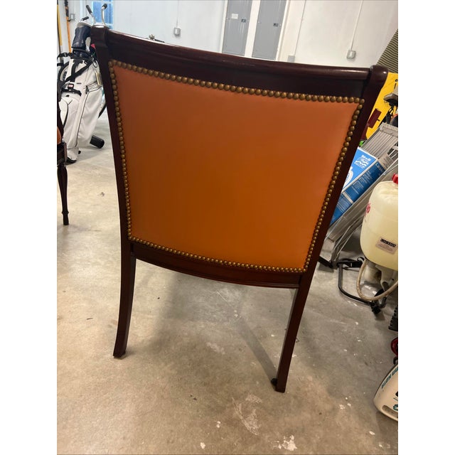 This vintage brown caned arm chair with brass nailhead trim by Hickory Chair exudes a timeless charm and sophistication....