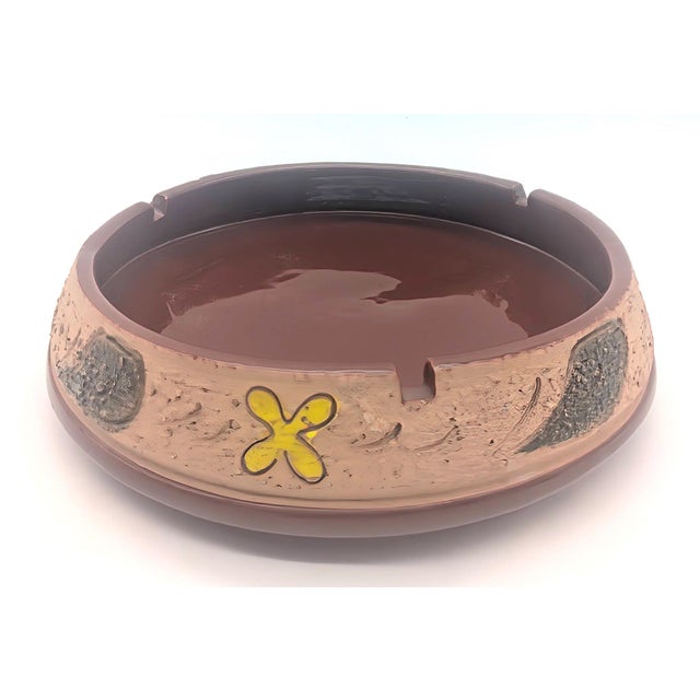 Offered is a mid 20th Century, circa. 1960s, Italian-made hand-thrown pottery ashtray that has a glossy brown glaze as...