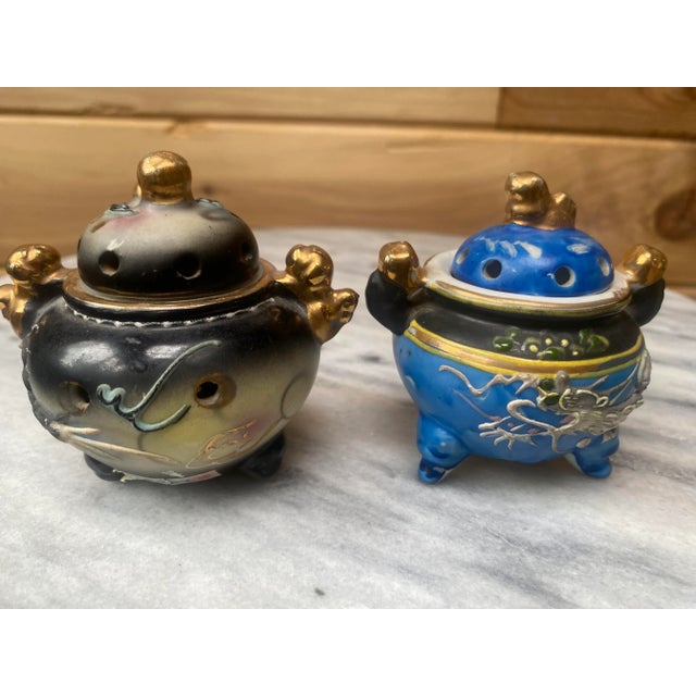 A beautiful pair of Japanese handpainted Moriage porcelain incense holders, one slate gray and the other a complimentary...