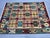 This Afghan Chobi wool kilim features a colorful geometric design with traditional tribal motifs in burgundy red, teal...