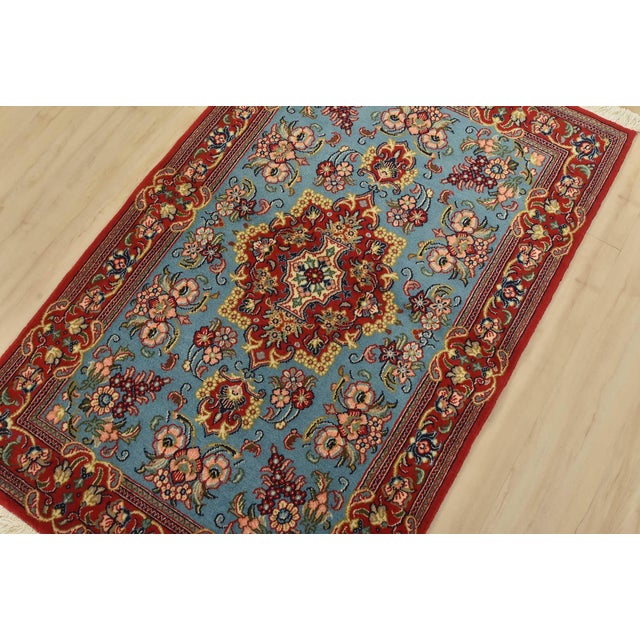 An authentic vintage traditional Qom rug hand-knotted with fine wool and natural dyes. This intricately woven rug features...
