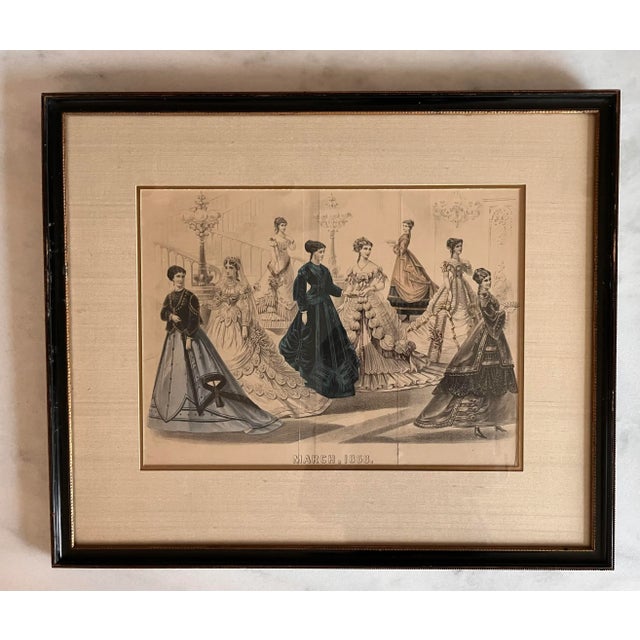 Pair of antique framed hand colored fashion advertisement prints/engravings. These original pieces are dated "March 1868"...