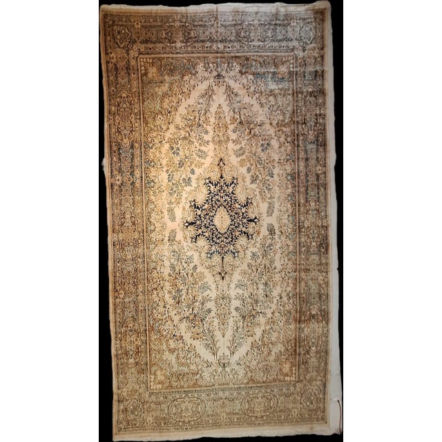 Circa 1930 Kerman Rug oversized. It has a central medallion design- an intricate dark blue (possibly navy) surrounded by...