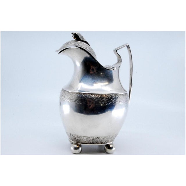 Silver Milk Jug with Friezes on the Lid, in Very Good conditions. Designed before 1890 This piece has an attribution mark,...