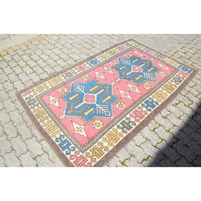 This is a vintage Turkish Oushak rug from the 1960s. The piece was hand-knotted.