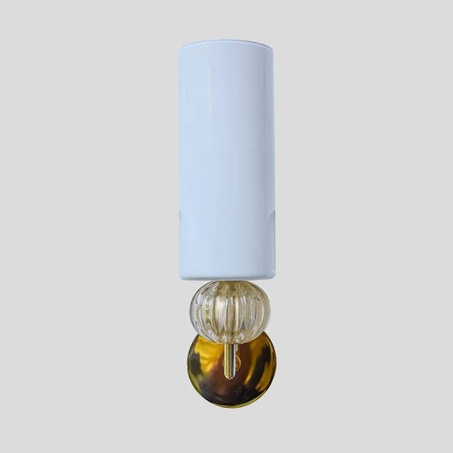 A pair of wall sconces, the shade is made of blown glass white opaline colour , with a clear and gold inclusion glass...