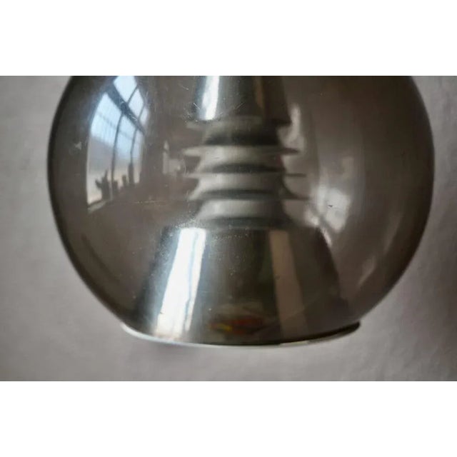 This pretty lamp with a futuristic design lamp is an original production from the 70s. The light device is original and...