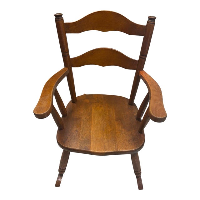 A charming mid-20th-century child’s rocking chair by Ramsdell of Gardner, Massachusetts, retaining its original factory...