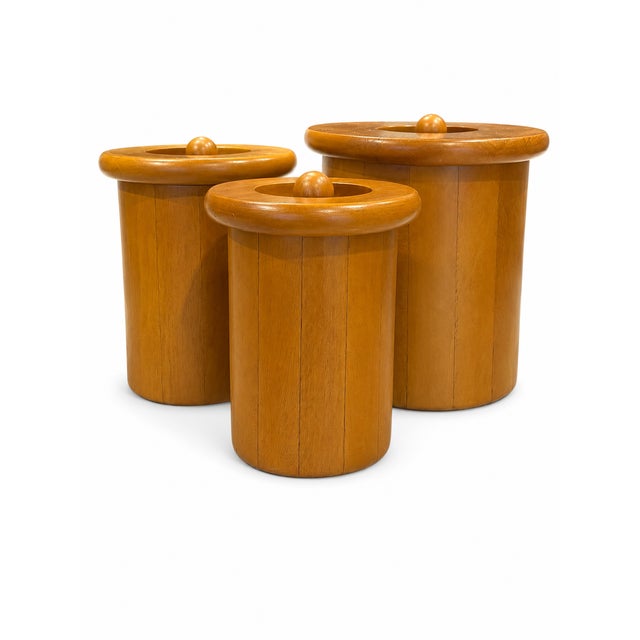 Beautiful vintage Scandinavian-style turned wood canister set featuring warm honey-toned wood, softly rounded silhouettes,...