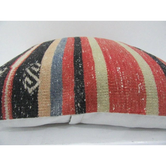 This is a pillow cover made from a vintage kilim rug. The piece was properly washed and ready to use. Pillow inserts not...