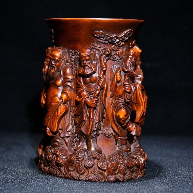 This exquisite pen holder is crafted from high-quality boxwood and features intricate carvings of the Eight Immortals, a...