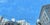 Connection by Stephanie Hartshorn | Oil on wood panel Cityscape with blue sky and buildings. For Sale