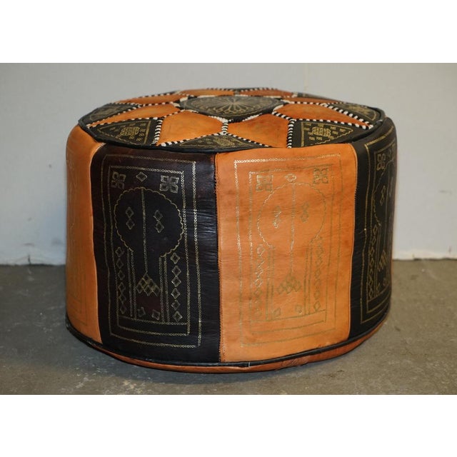 Here we have for sale this lovely vintage Mid-Century Modern leather patch work footstool pouffe. This Pouffe screams mid...