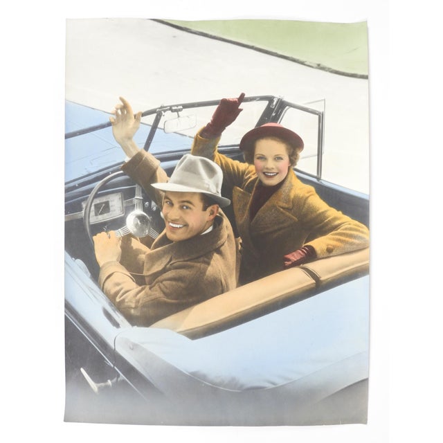 Early 20th century colortone advertising photograph of a man and woman waving from their convertible car. Unsigned....
