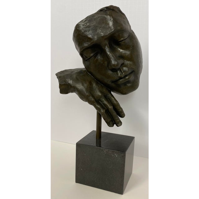 Bronze figurative sculpture after Salvador Dali (1904-1989) mounted on black marble pedestal. Measures: 17.75" High x...