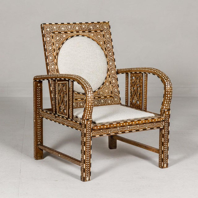 This Anglo-Indian armchair showcases exquisite craftsmanship and cultural heritage through intricate bone inlay featuring...