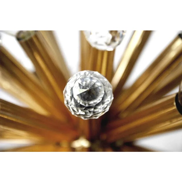 This stunning chandelier was manufactured by Ernst Palme in German Westheim during the 1960s. This lamp has a gilt brass...