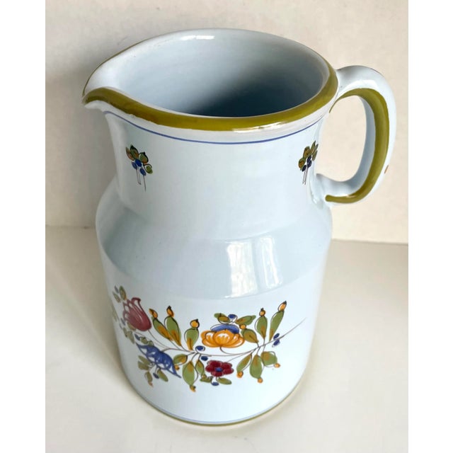 Here is a wonderfully made ceramic pitcher with handle that was made in Italy. Signed on the bottom. The pitcher has trim...
