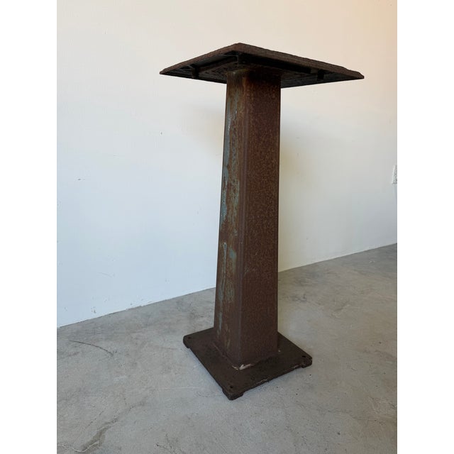 Striking vintage Brutalist-style metal pedestal featuring a richly textured, embossed square top with intricate floral and...