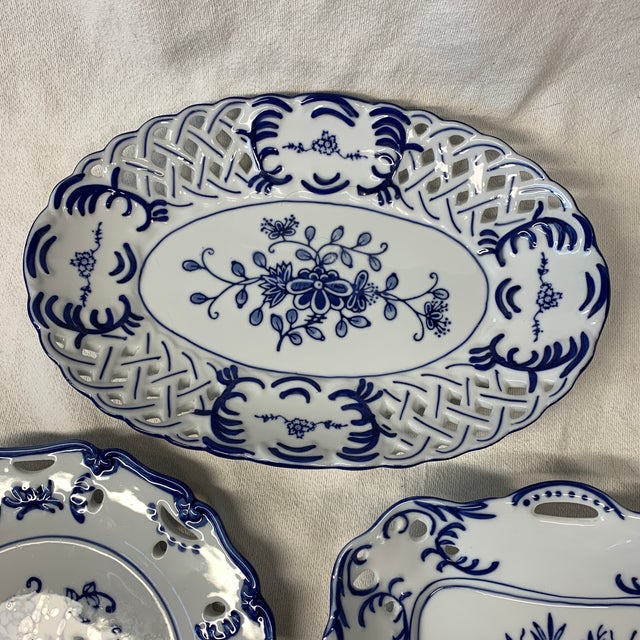 These are vintage Lillian Vernon blue and white porcelain decorative plates featuring classic floral transfers and woven...