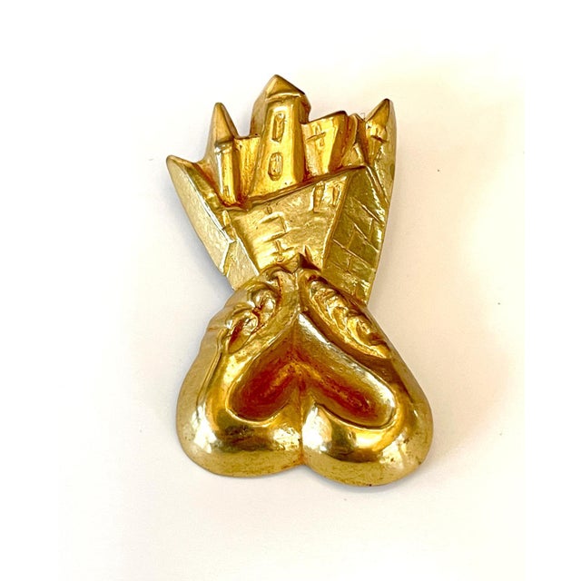 A small gilt bronze brooch named "Chateau en Espagne" by French Parisian art jewelry and sculpture Line Vautrin...