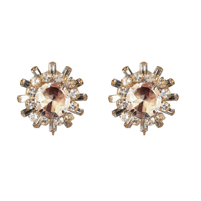 A stunning fusion of Art Deco elegance and metropolitan flair, the Isabella Studs feature a bold round centerpiece framed...