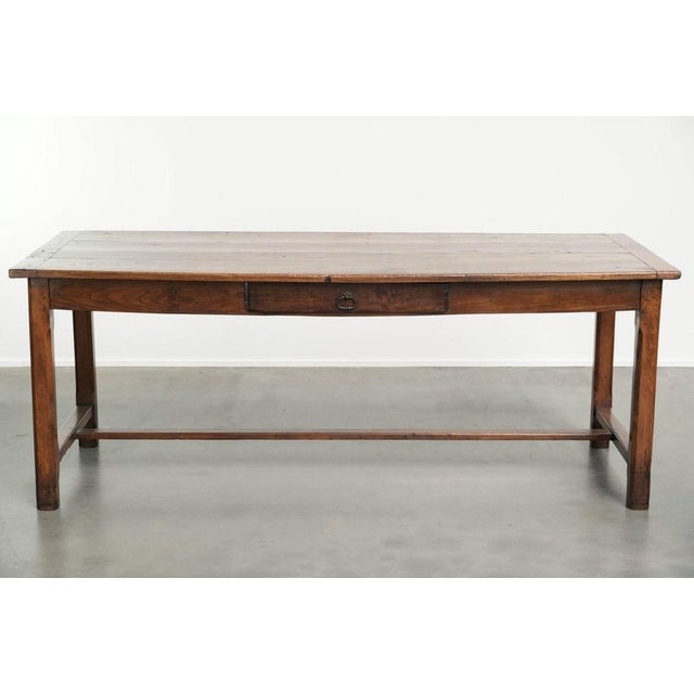 This beautiful and characterful French farmhouse dining table dates from the 18th century and is made of oak and fruit...