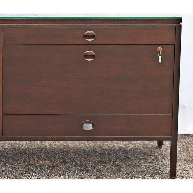 Elegantly crafted credenza made of walnut. Credenza features distinctive half moon drawer and door pulls.