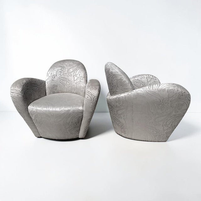 Fabulous pair of award-winning Miami swivel lounge chairs by Michael Wolk. All hardwood frame with interlocking,...