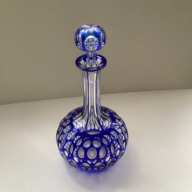 Classic Czech Cobalt blue cut crystal decanter with clear thumbnail design. Tall collared neck and cut crystal stopper....