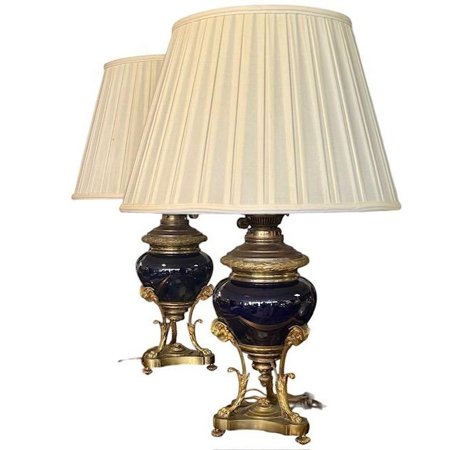 Stunning pair of mid 19th century oil lamps with ink blue glass fonts on ornate brass and gilt animal tripod stands with...
