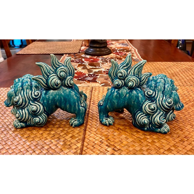 Rich turquoise marbling highlights this pair of ferocious foo dogs, originally created to protect the owners home from...