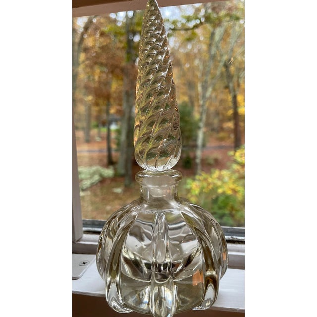 This vintage glass perfume bottle is so gorgeous because of the molding, the swirls, and the way it reflect the light....